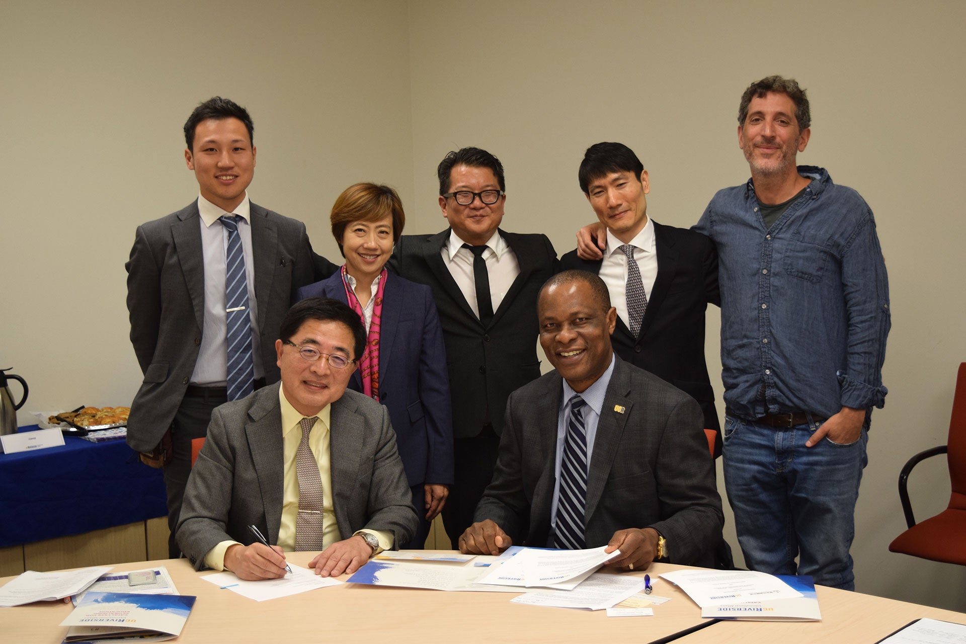 Representatives from TUFS and UCR sign agreement