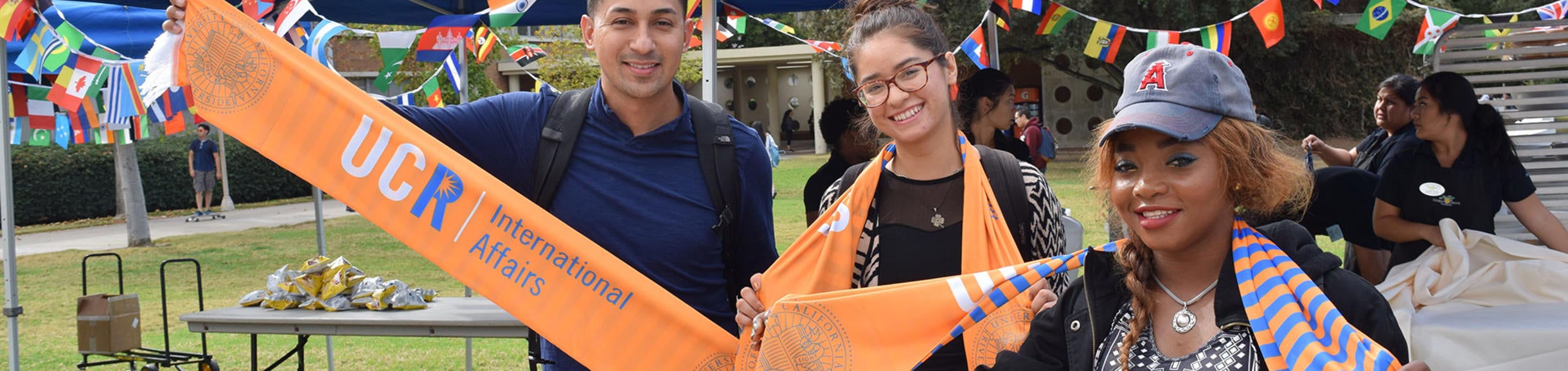 Group of UCR students posing with International Affairs scarves